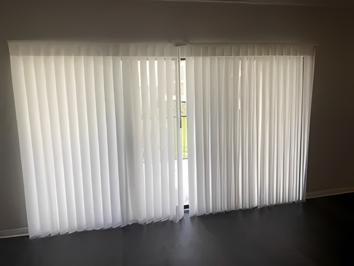 White blinds with natural light peeking through