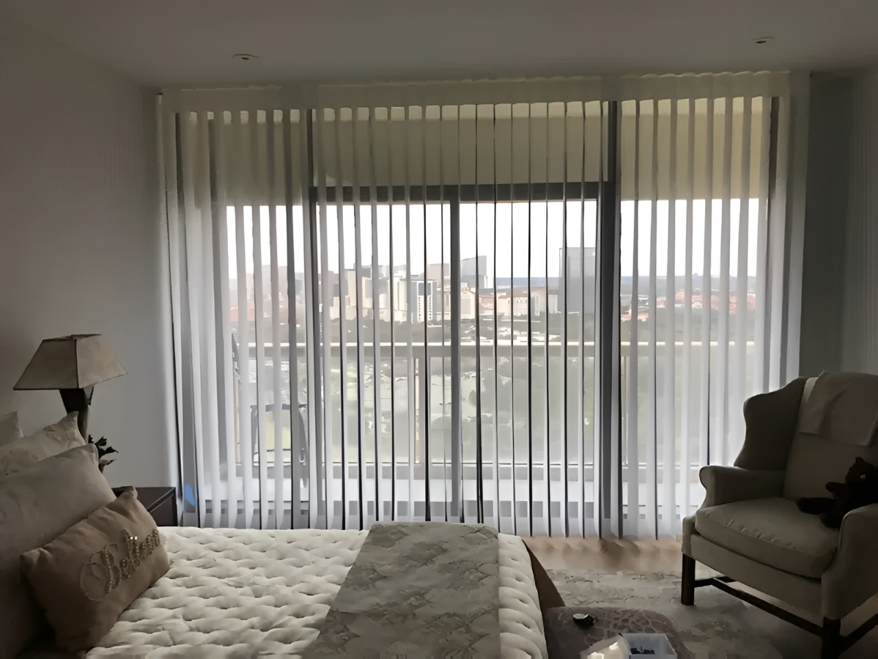 Bedroom with large window and sheer curtains