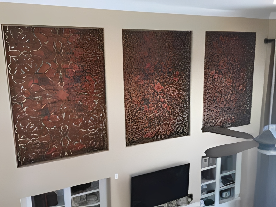 Three abstract metal panels on wall