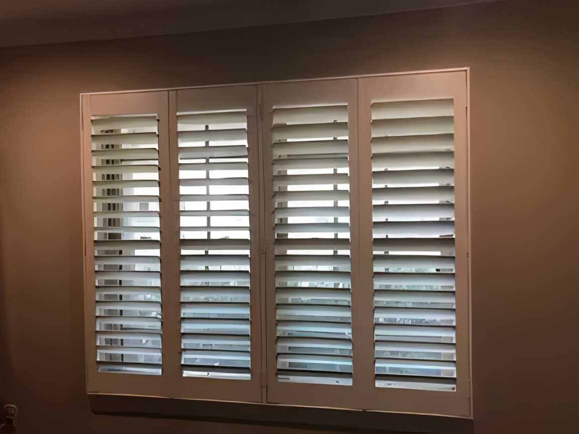 Interior window with louvered shutters