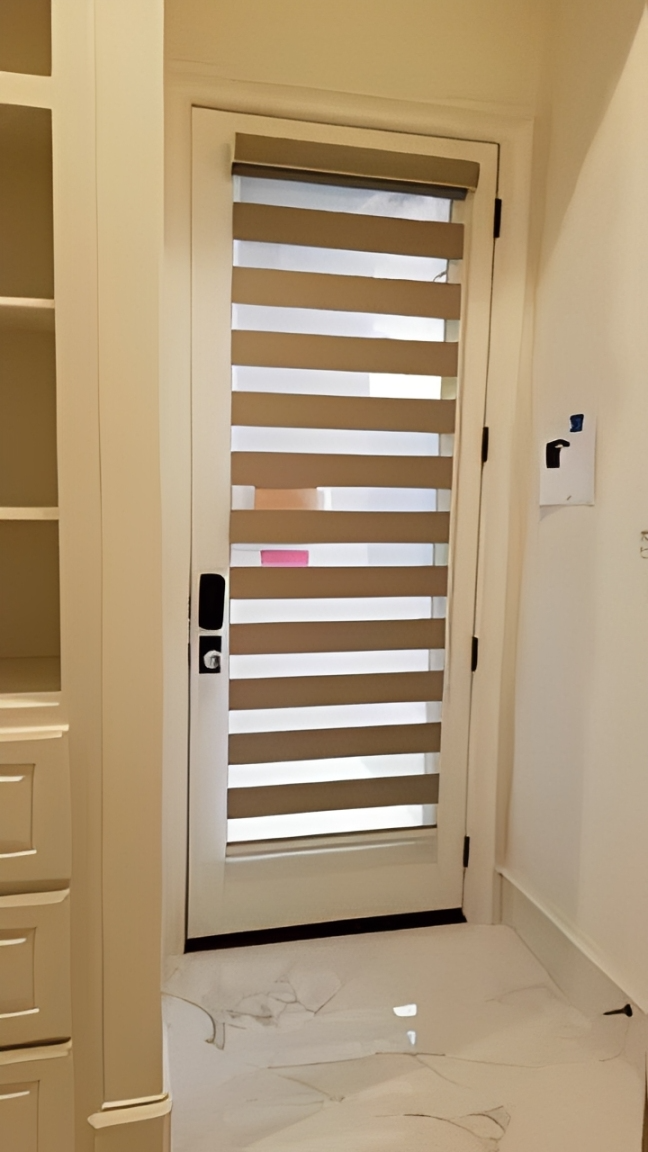 Light filtering blinds on white door