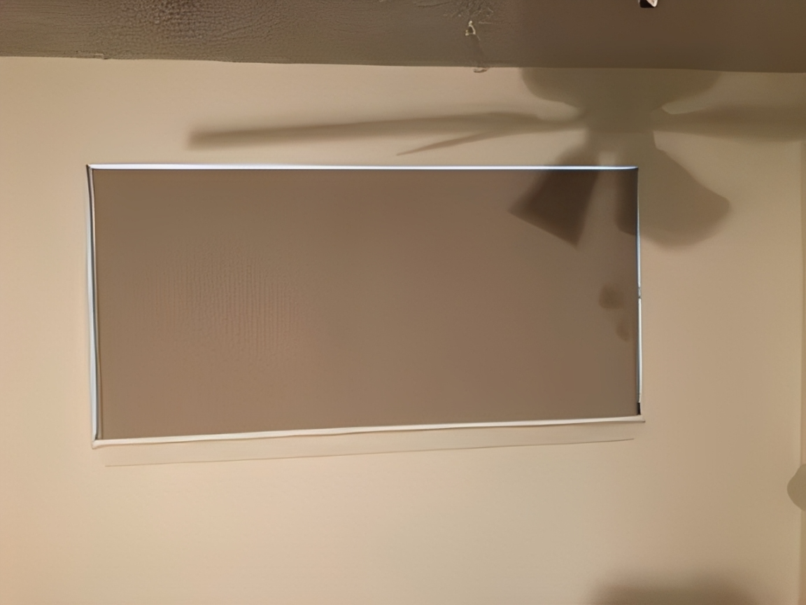 Closed window blind with ceiling fan shadow