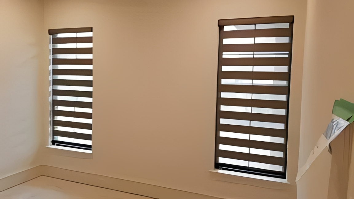 Room featuring dual striped window blinds