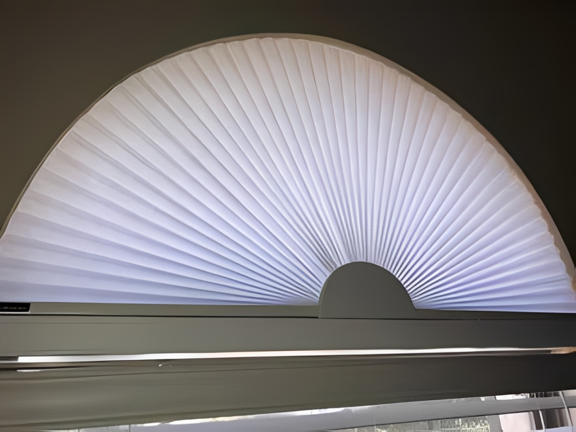 Arched window featuring a closed blind