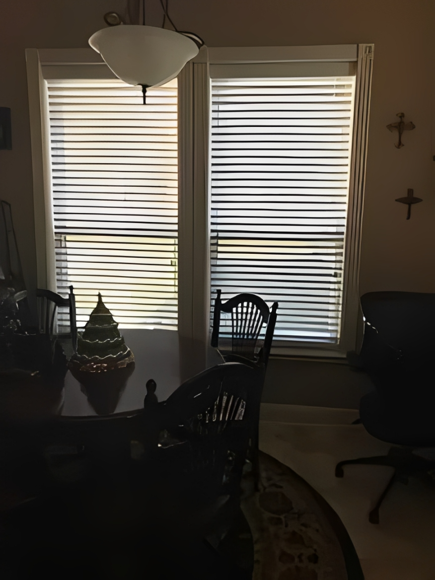 Sunlit room with blinds and dining table