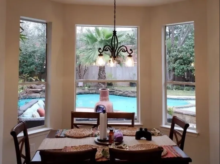Dining area overlooking a backyard pool