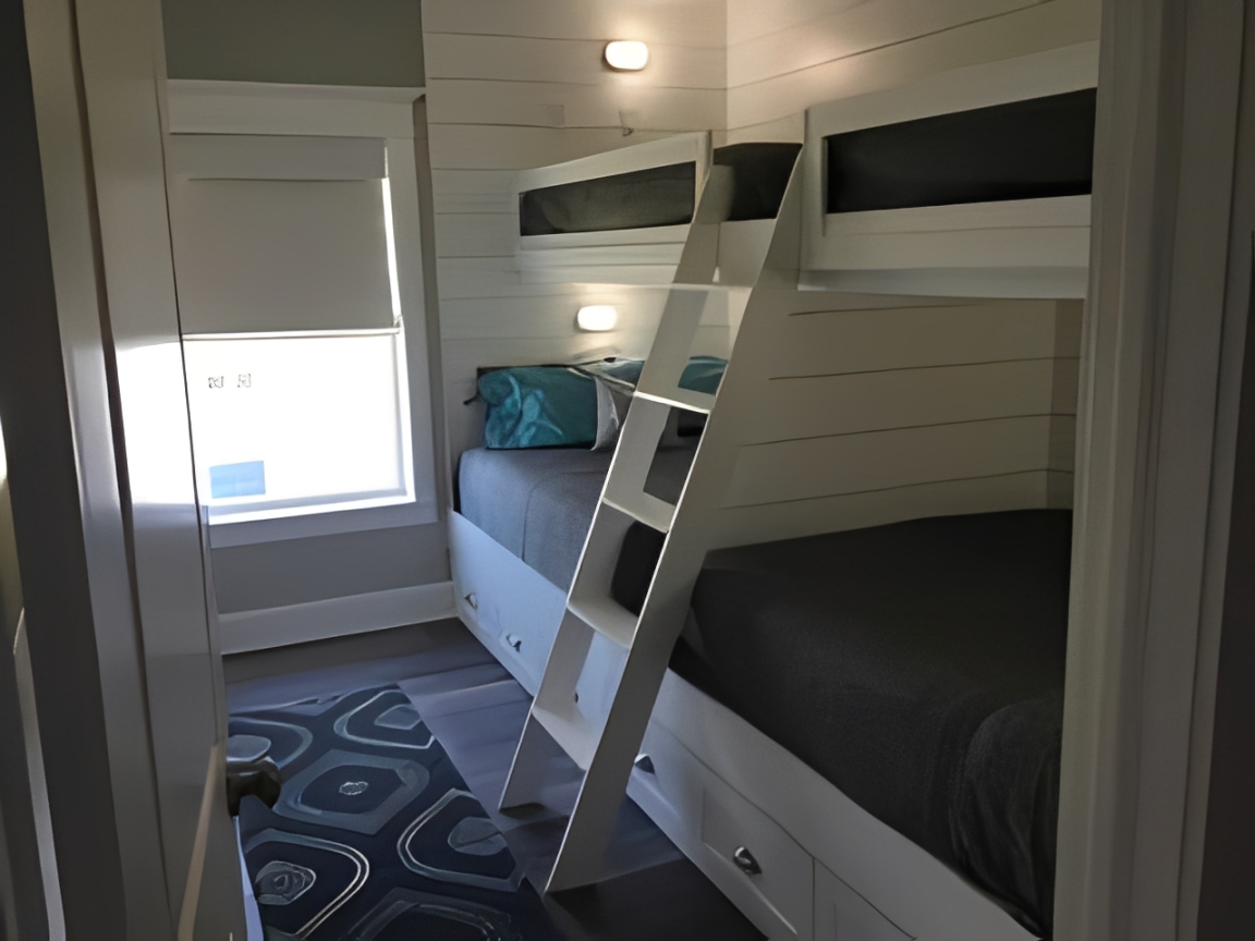 Small bedroom featuring bunk beds and rug