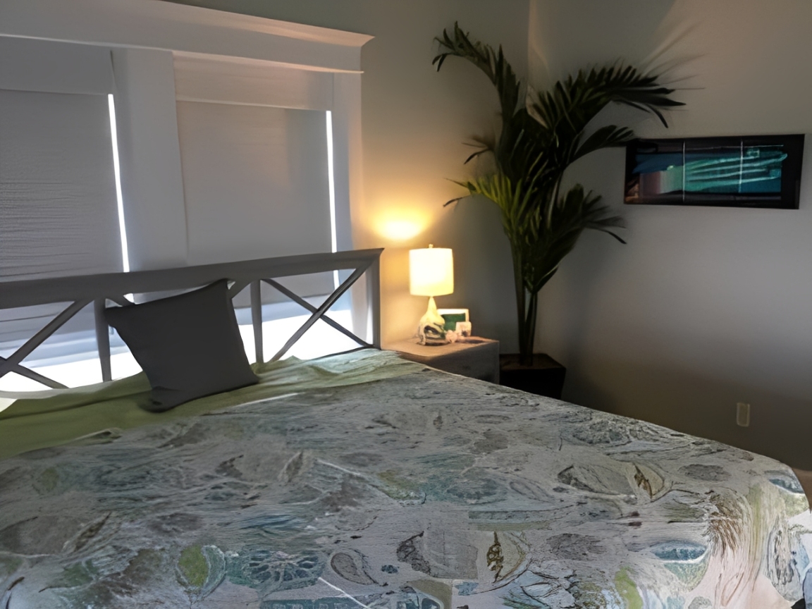 Bedroom with bed and nightstand lamp